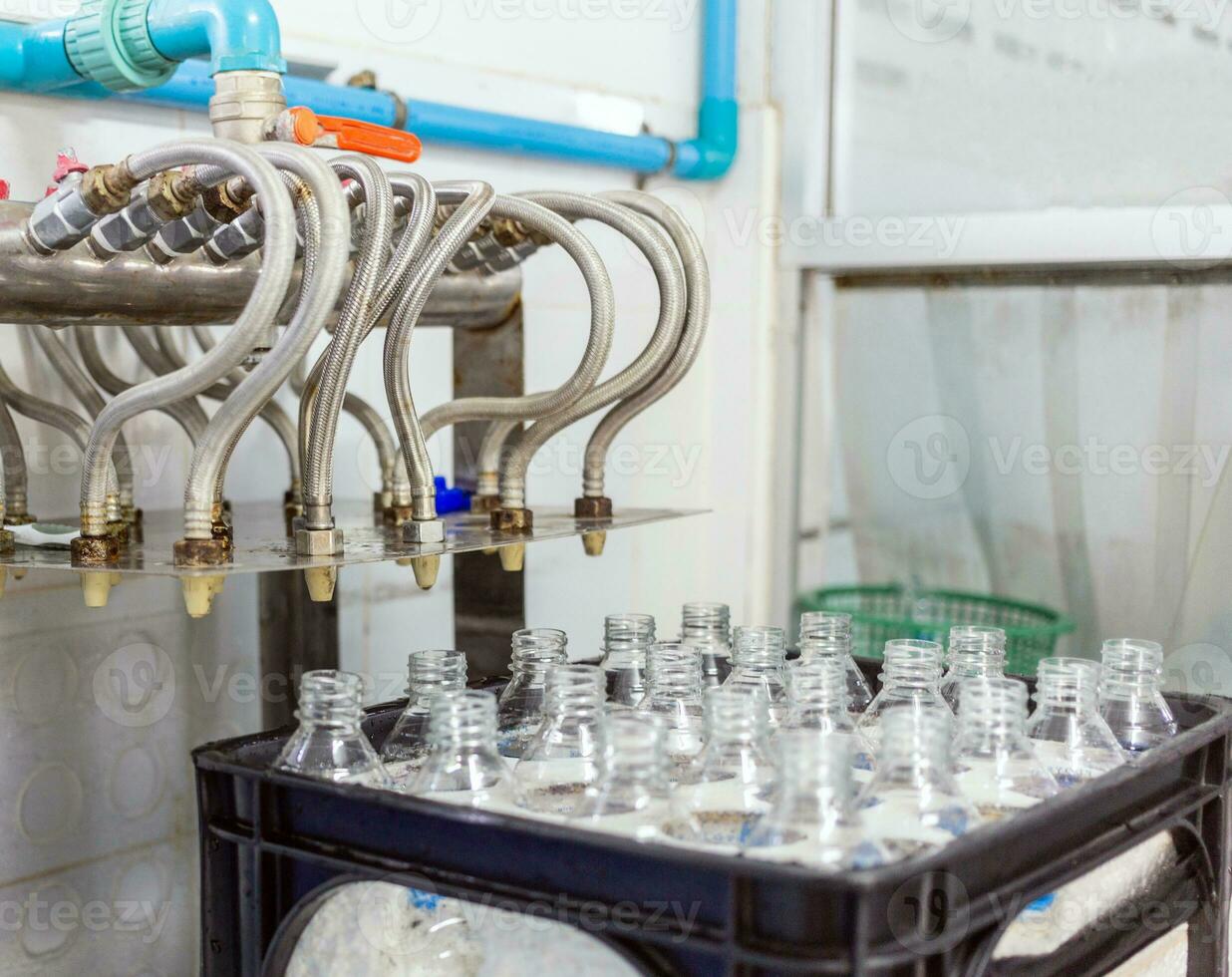 Bottling plant-Water bottling line for processing and bottling drink water into bottles. Bottle filling with drink water poured in a clear plastic bottle photo