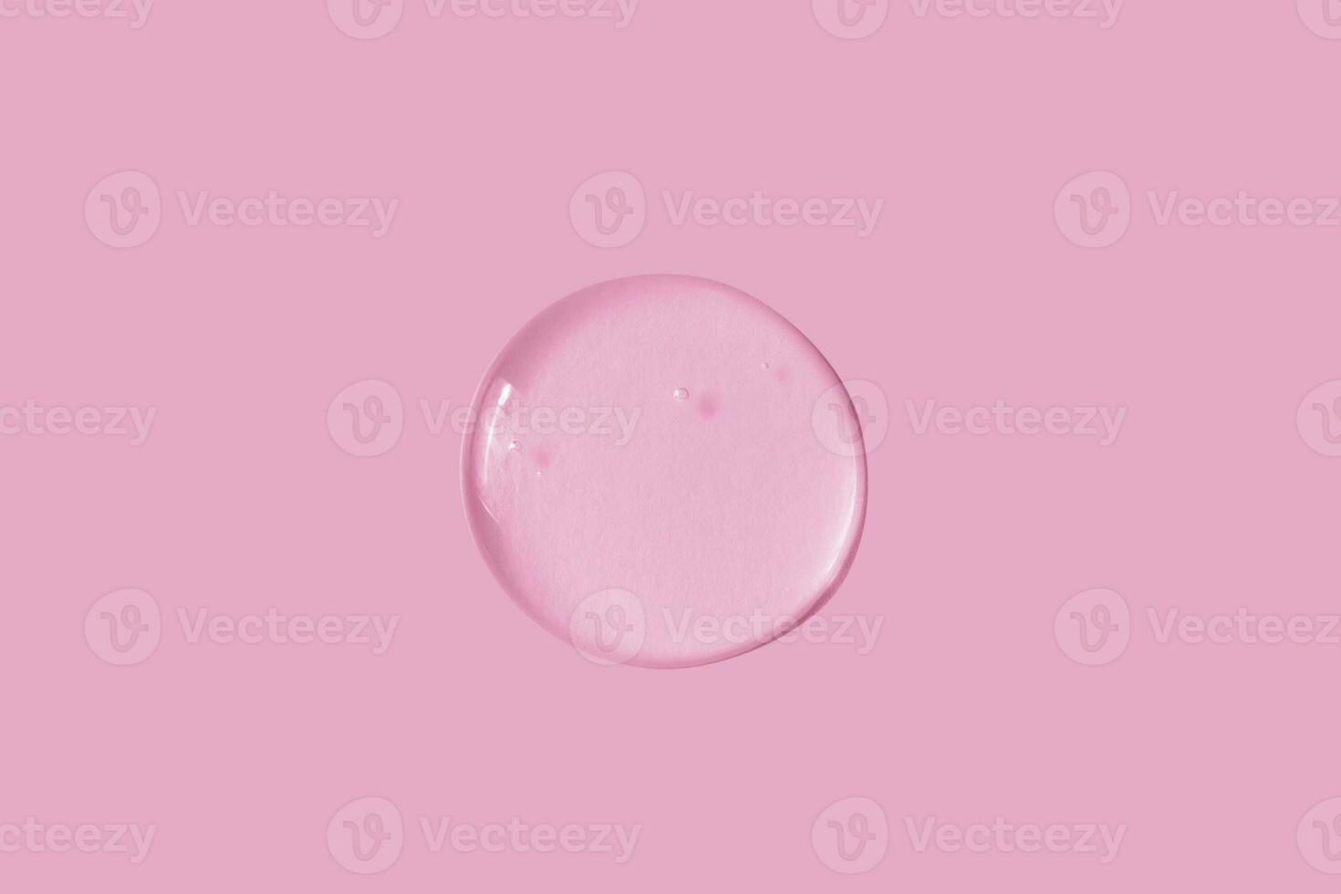 texture of a large smear of transparent gel on a pink background photo