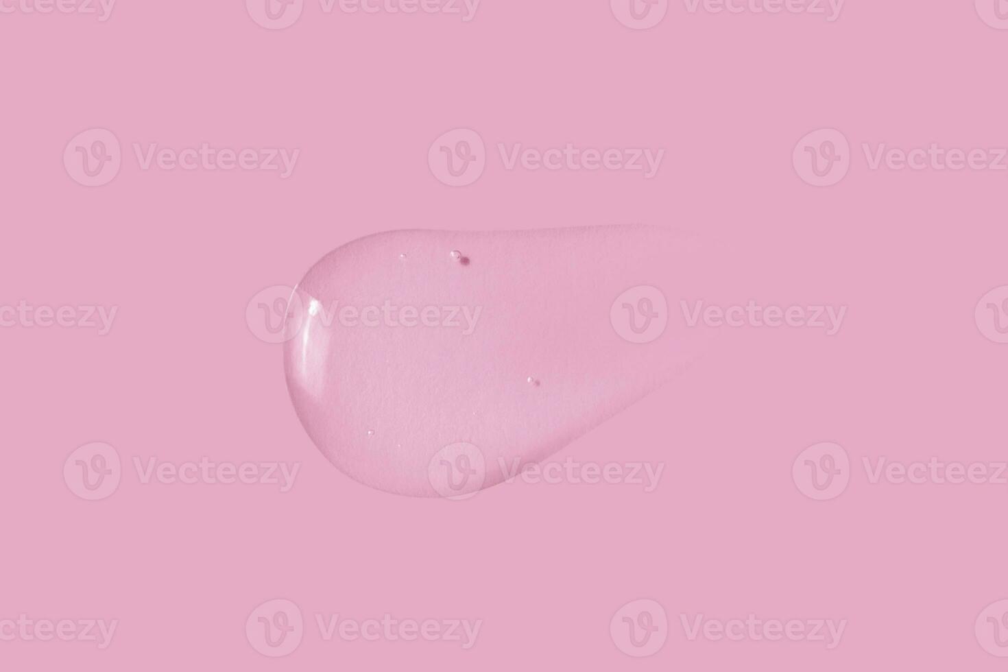 texture of a large smear of transparent gel on a pink background photo
