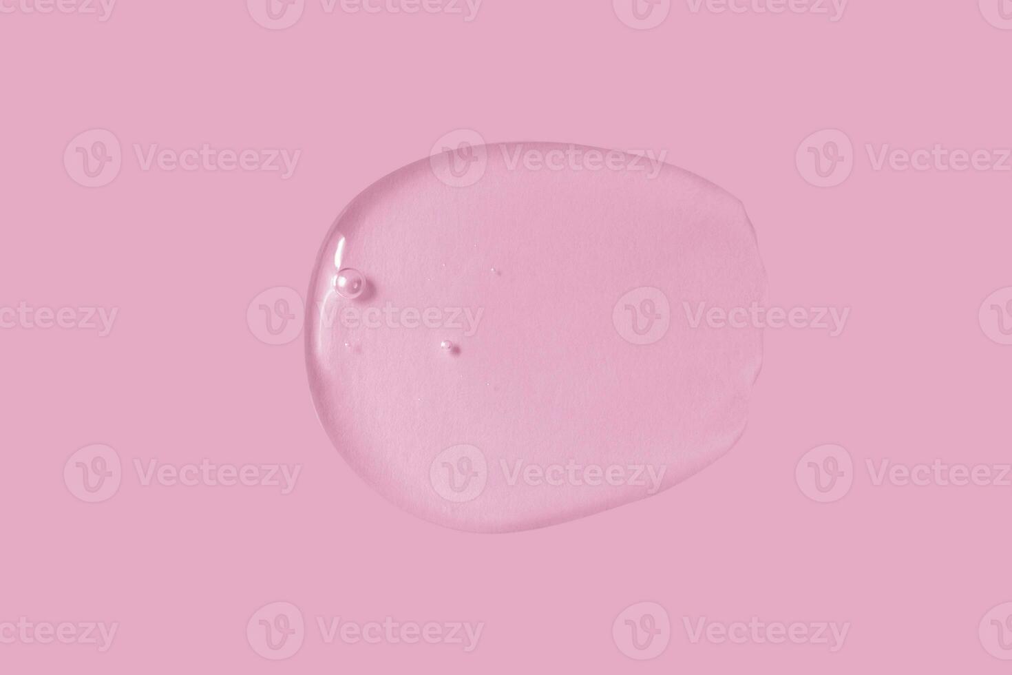 texture of a large smear of transparent gel on a pink background photo