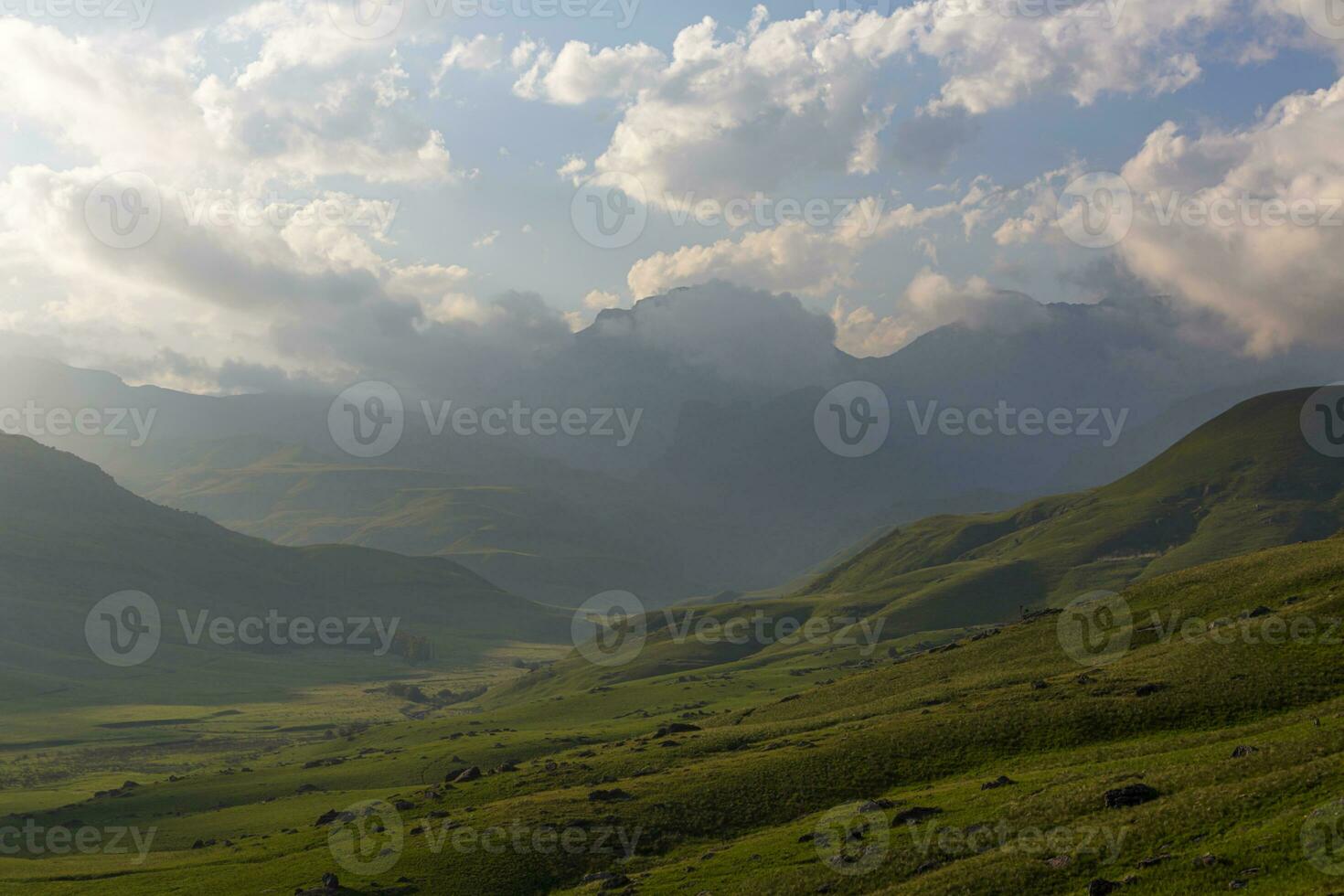 Late afternoon clouds over green valley photo