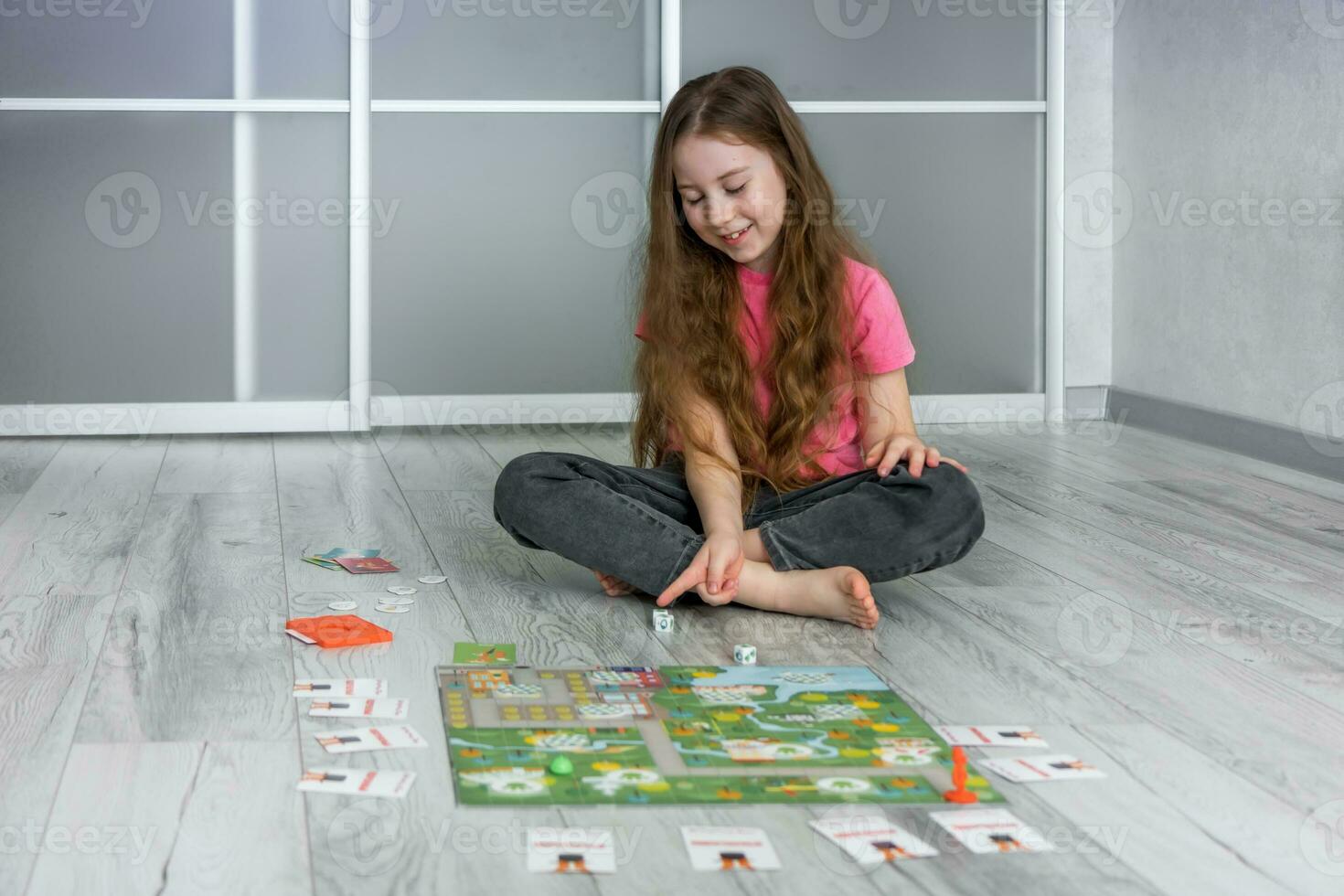 cute girl with a smile counts the dropped out points on playing dice, entertainment photo
