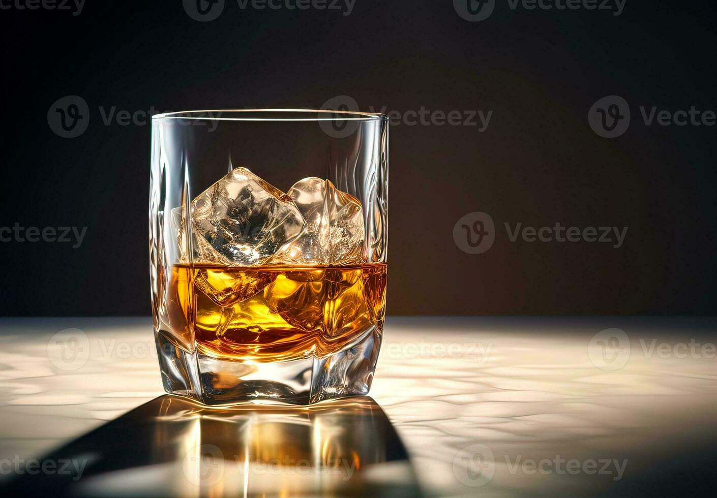 Whiskey with ice in glass on black background photo