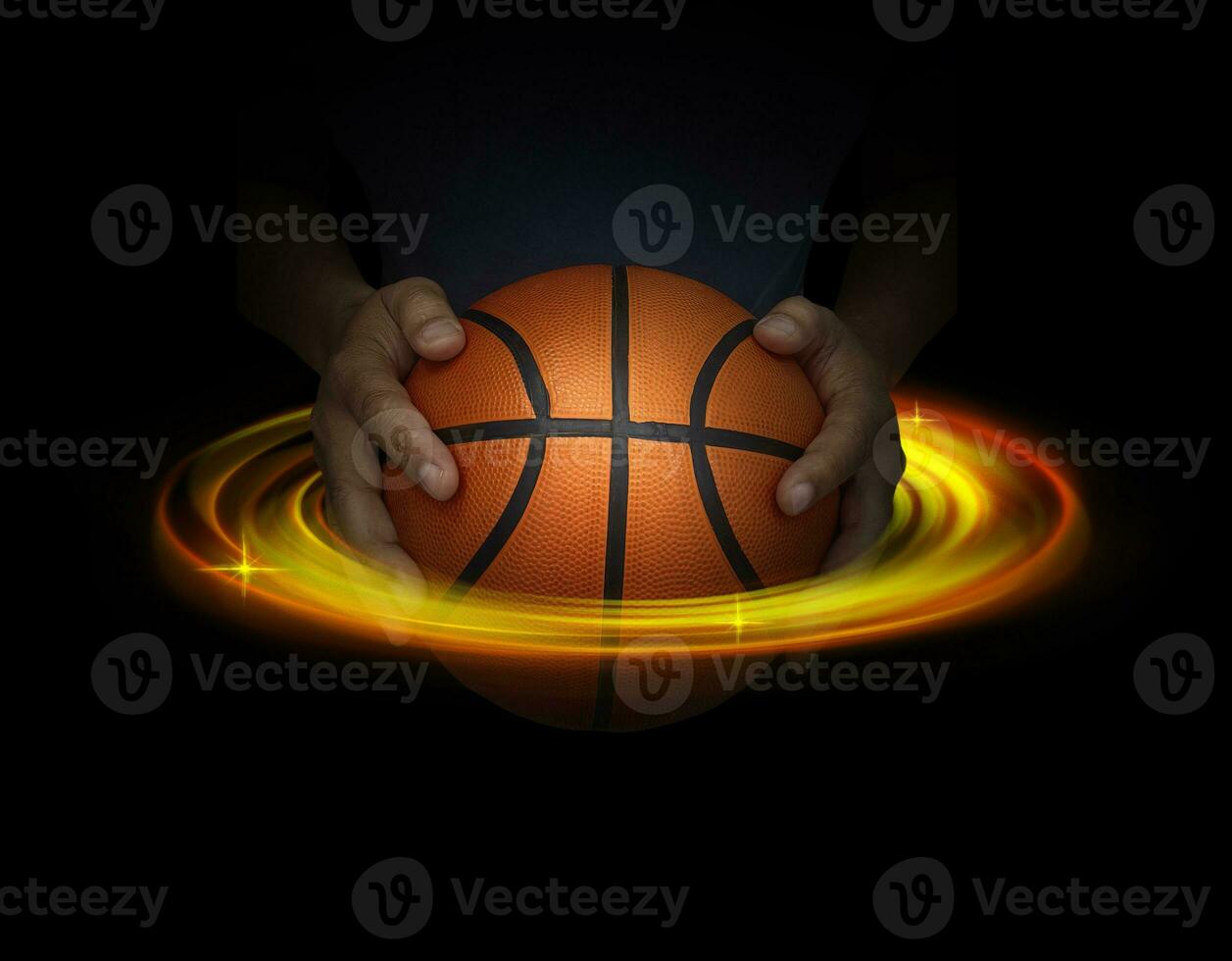 Basketball ball in male hands on black background with abstract lights. Basketball game concept photo