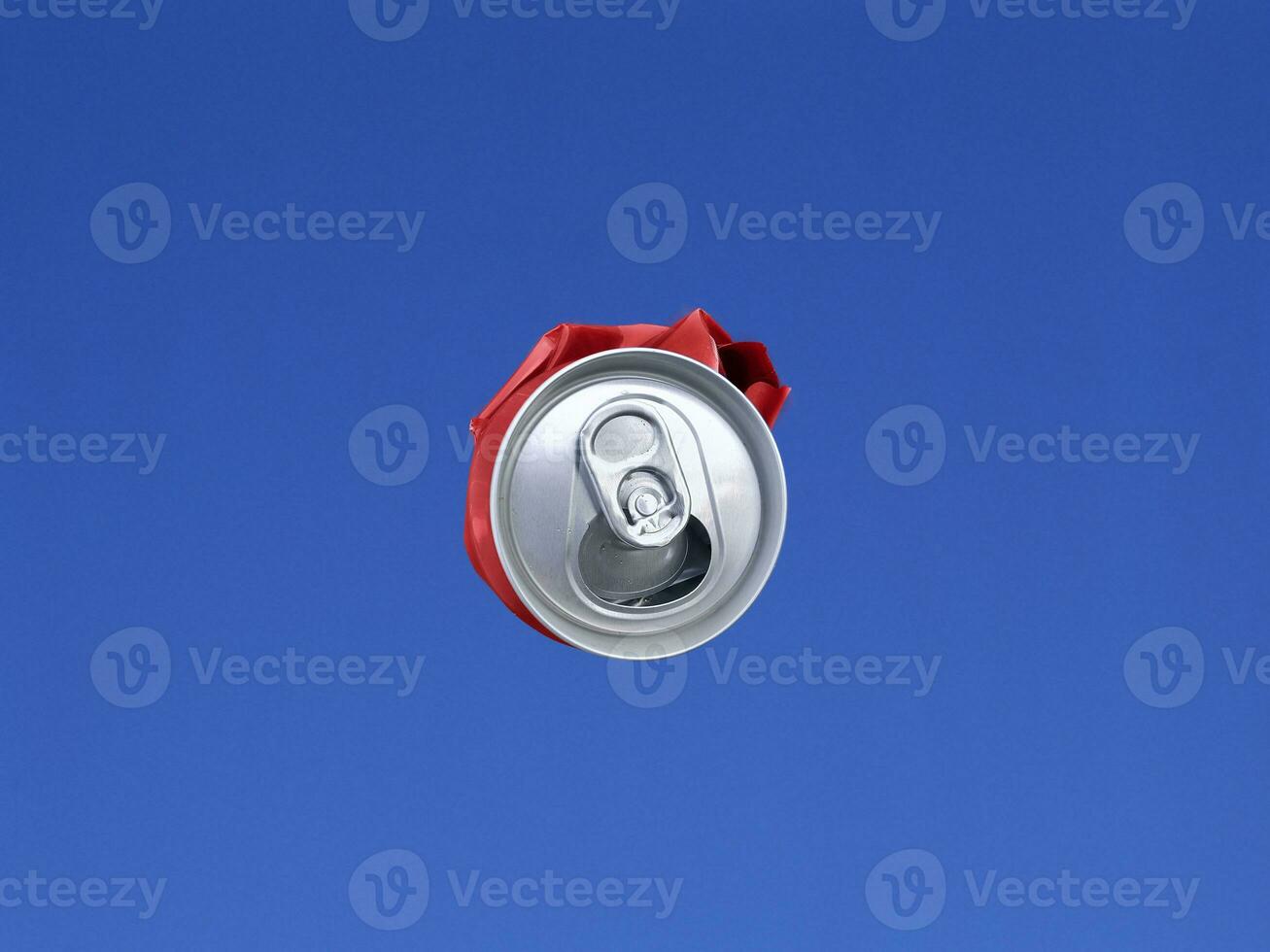 Compressed cans shot in the air with blue sky background photo