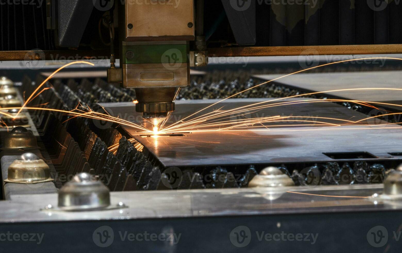 Laser cutting head for metal processing metal factory spark background, Processing and laser cutting for metal in the industrial photo