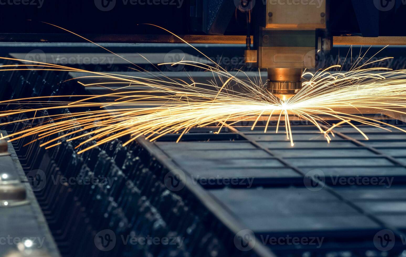 Laser cutting head for metal processing metal factory spark background, Processing and laser cutting for metal in the industrial photo