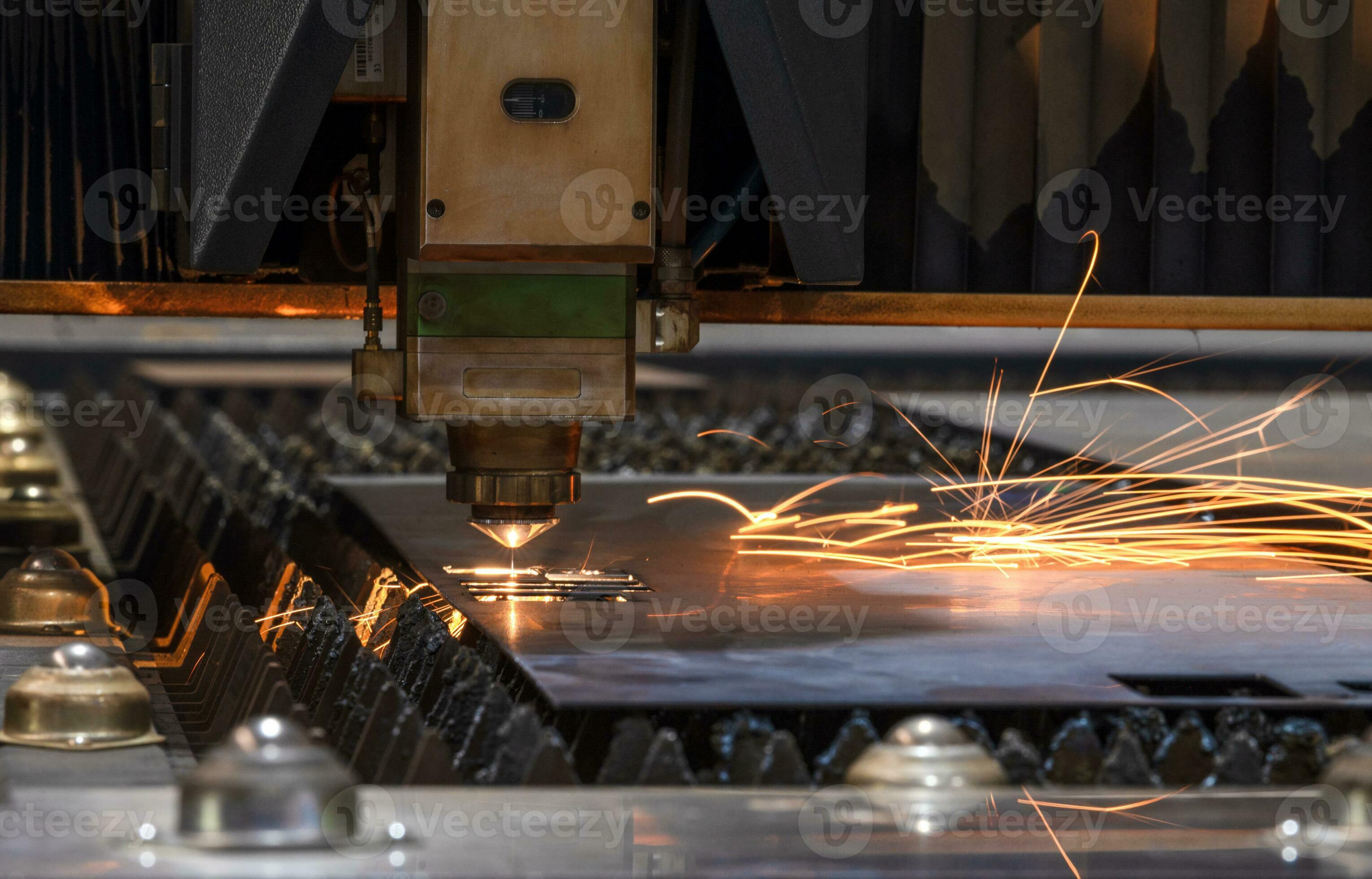 Laser cutting head for metal processing metal factory spark background