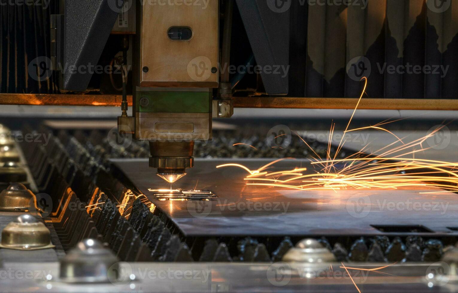 Laser cutting head for metal processing metal factory spark background, Processing and laser cutting for metal in the industrial photo