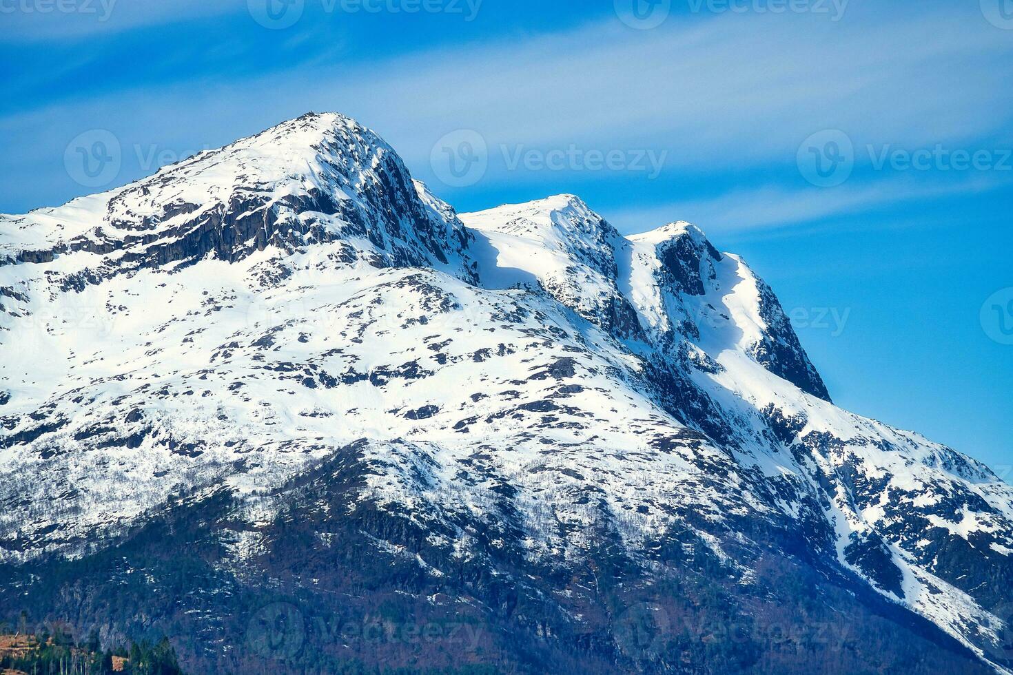 Snow covered mountain by the fjord in Norway. Scandinavian landscape in the north of Europe photo