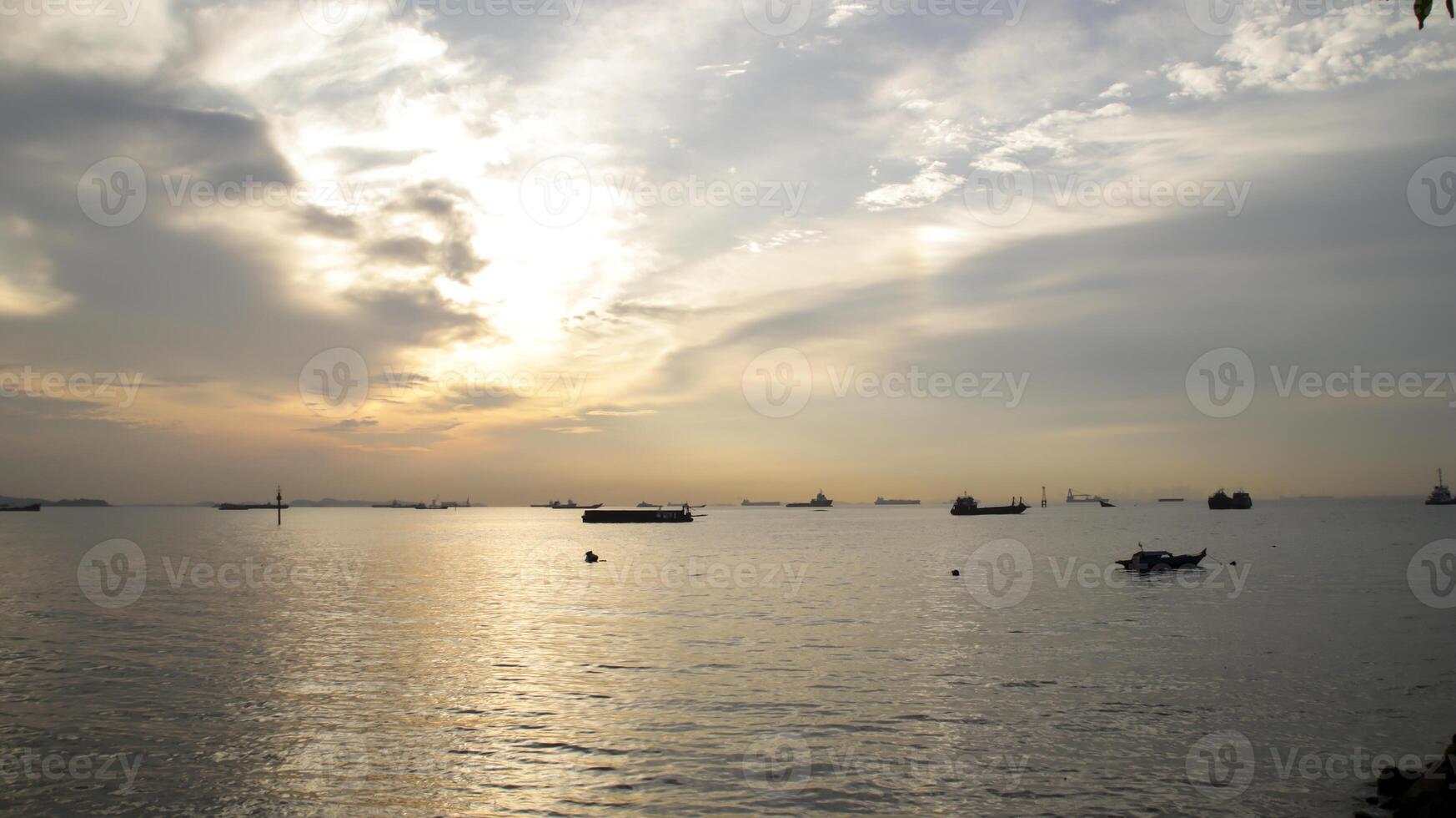 Stunning sunset seascape at the horizon in afternoon, view from the port or harbor. photo