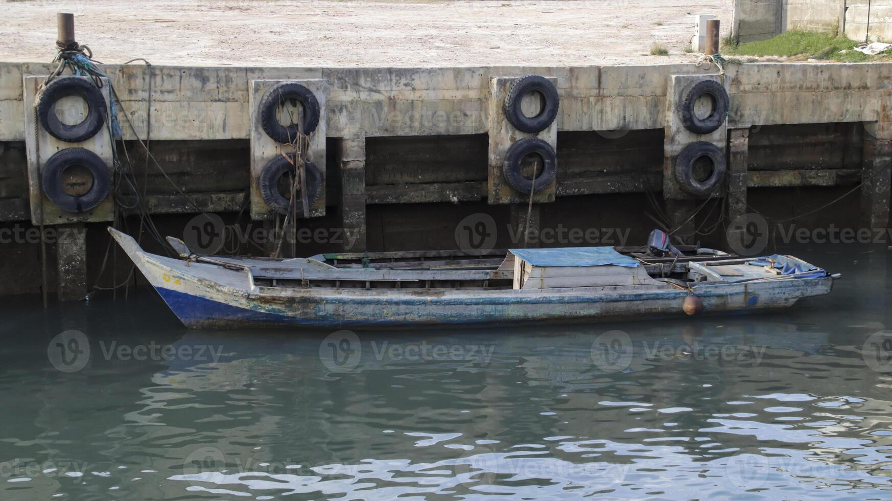 A small wooden fishing boat docking at the harbor. photo