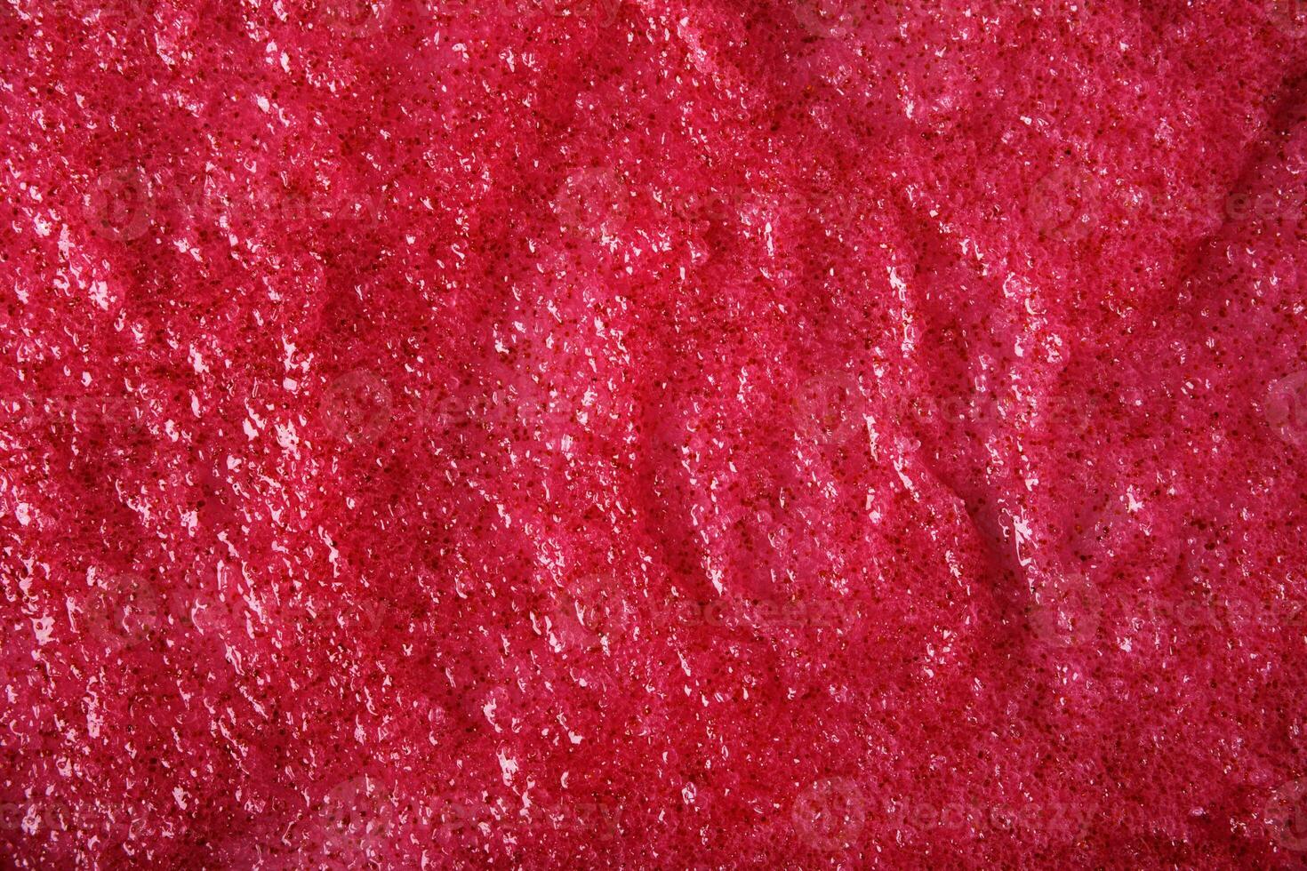 Texture of organic berry scrub with sugar and seeds. Close-up photo