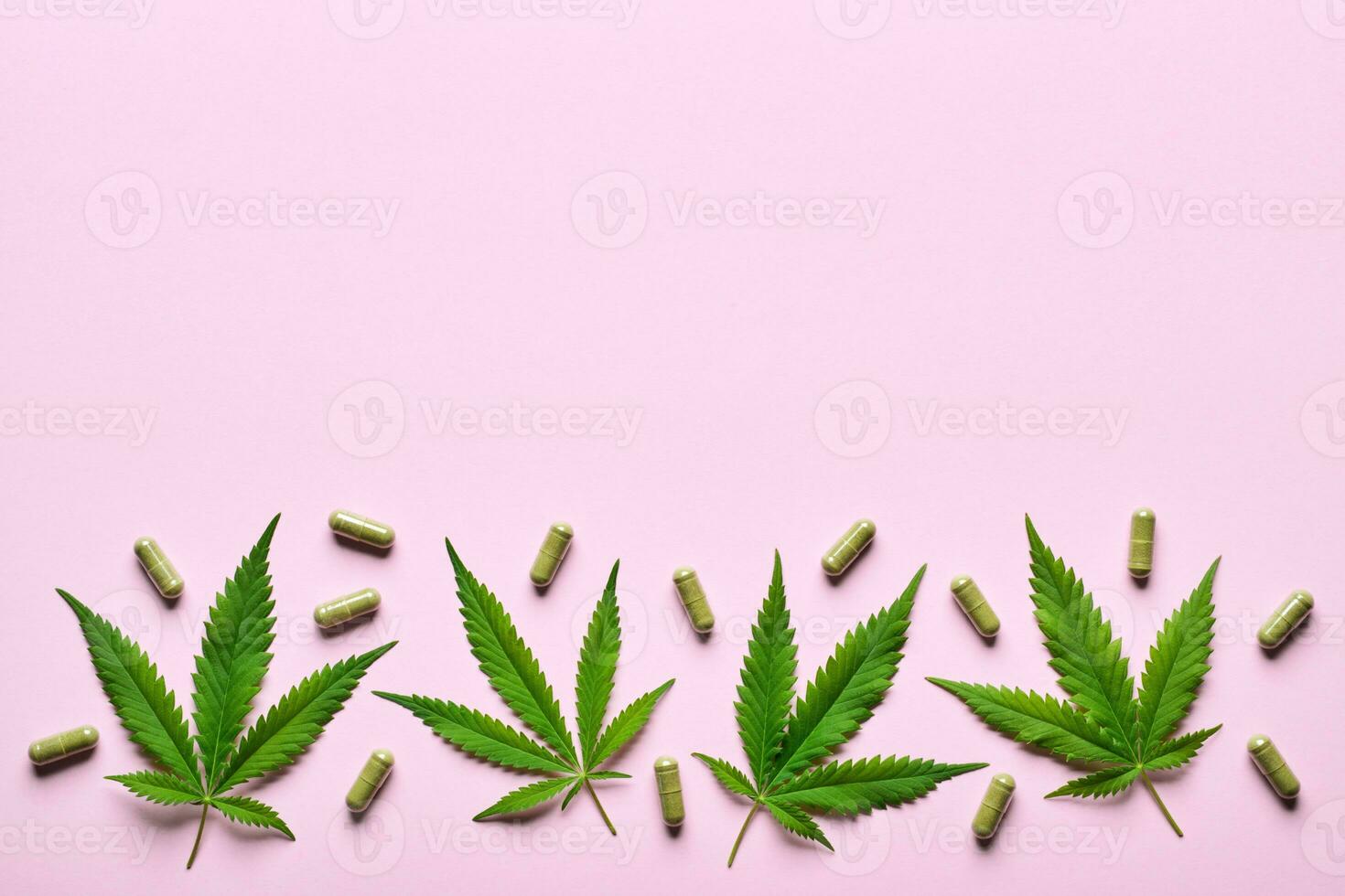 Cannabis extract capsules and hemp leaves pattern on pink background. Calming, anti-stress and sleeping concept photo