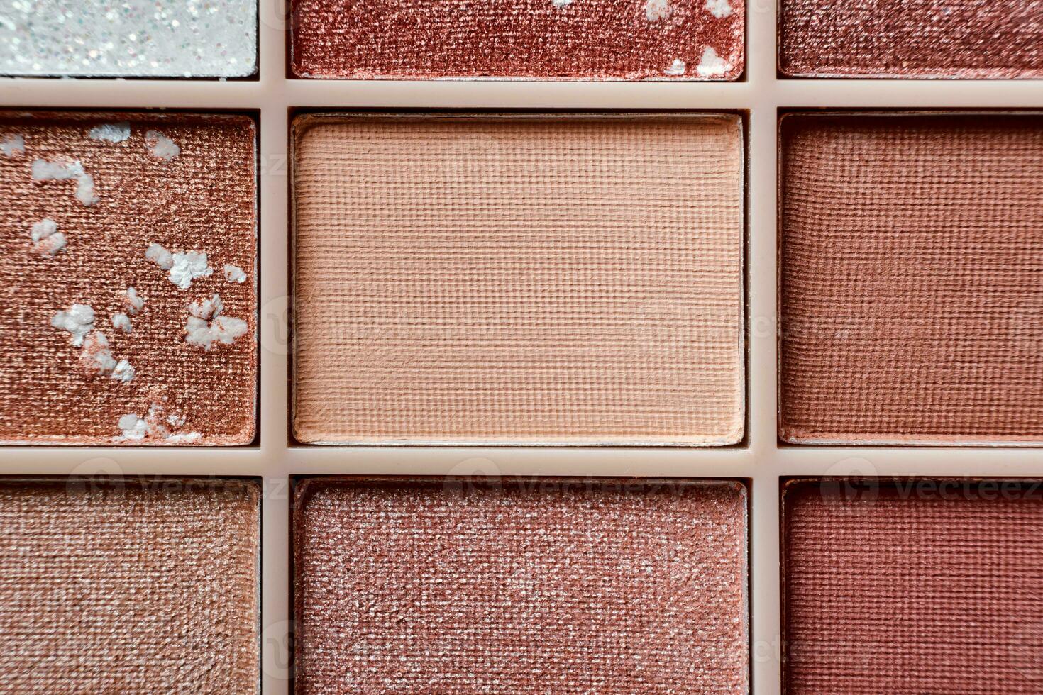 Eyeshadow colorful shades palette in beige tones close-up. Beauty abstract background. photo