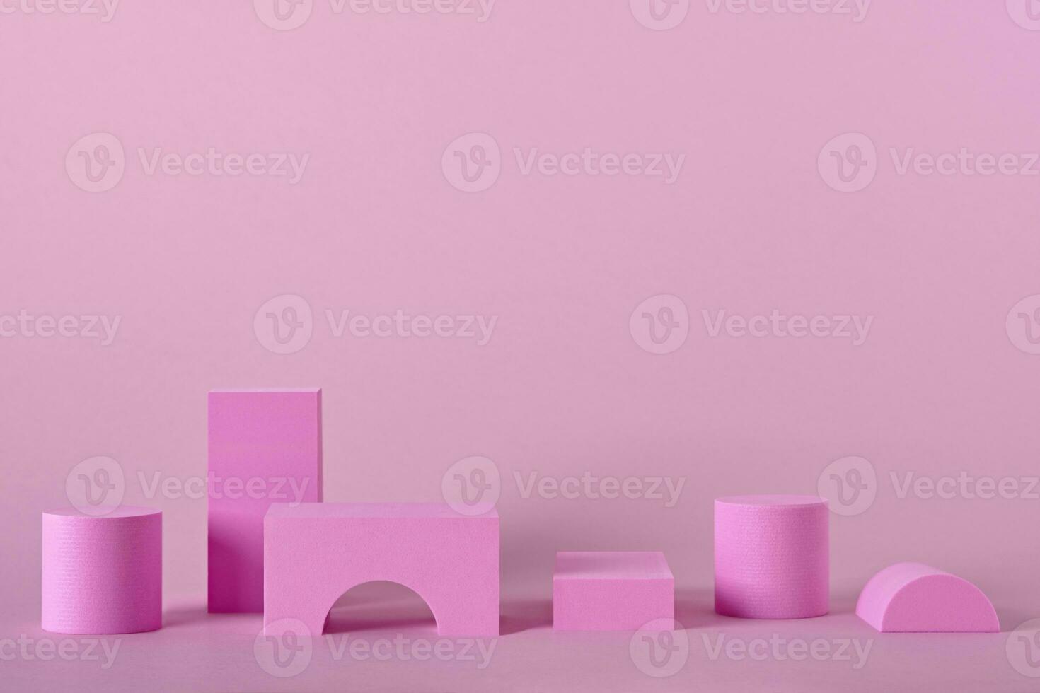 Abstract pink background with different shape podiums for products presentation or exhibitions. Geometric composition with copy space photo
