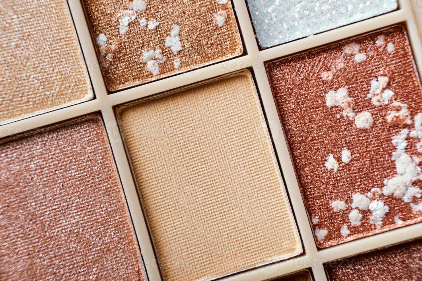 Eyeshadow colorful shades palette in beige tones close-up. Beauty abstract background photo
