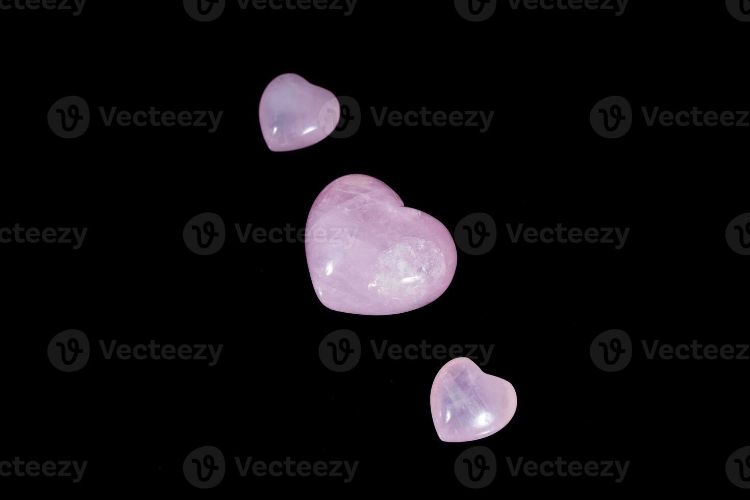 Macro mineral stone Heart pink quartz on a black background photo