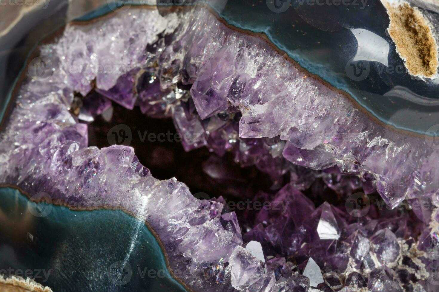 Macro Mineral Stone Amethysts in the rock on a white background photo