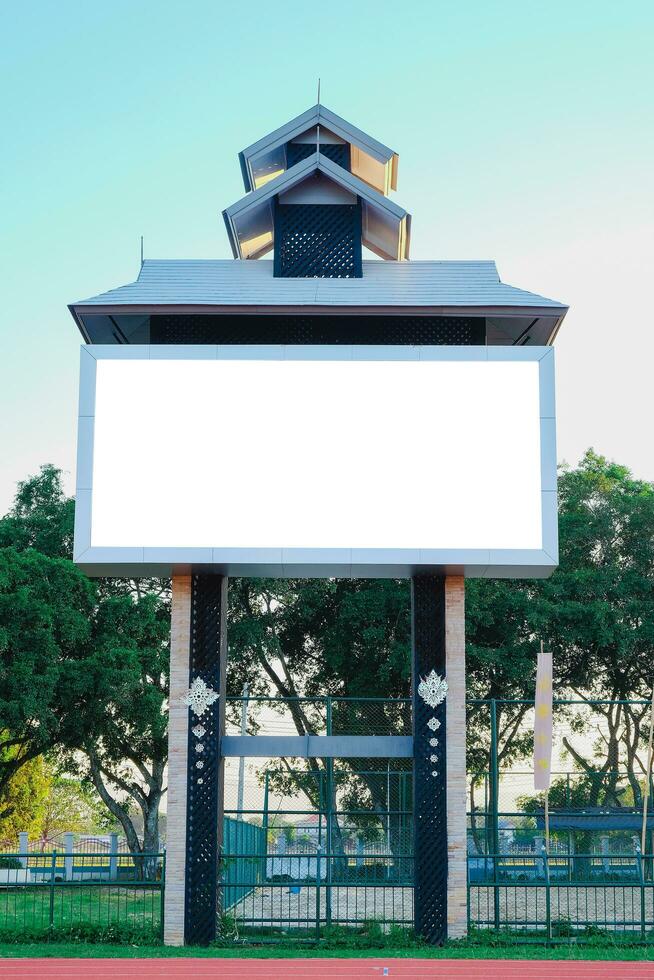 Blank advertising board with roof outdoor. photo