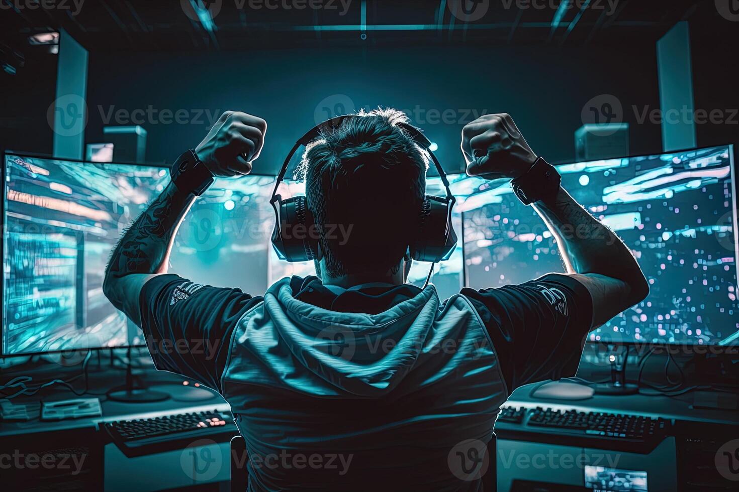 Professional eSports gamer rejoices in the victory in red blue illuminated game room. Gamer celebrating victory. Winning an eSports game. . Electronic sports player rejoices victory photo
