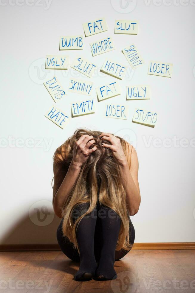 Depressed woman with her head down photo