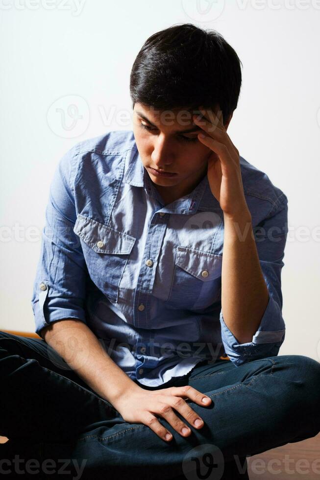 Depressed young man on the floor photo