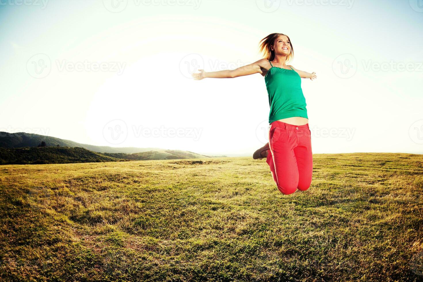 Woman jumping outdoors photo