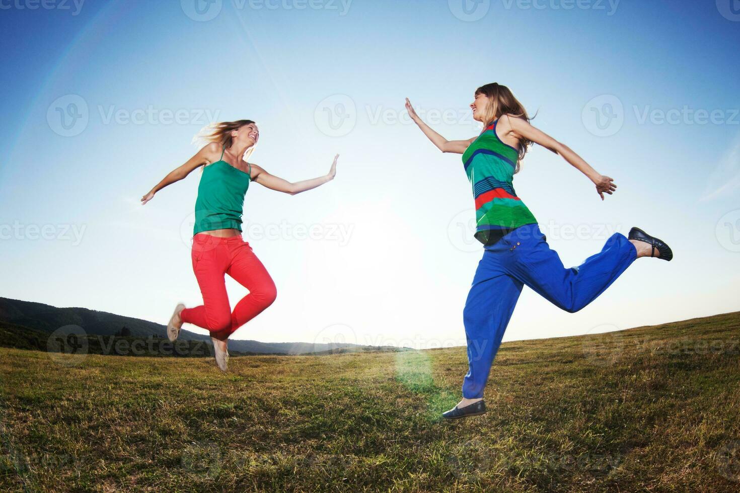 Women jumping outdoors photo