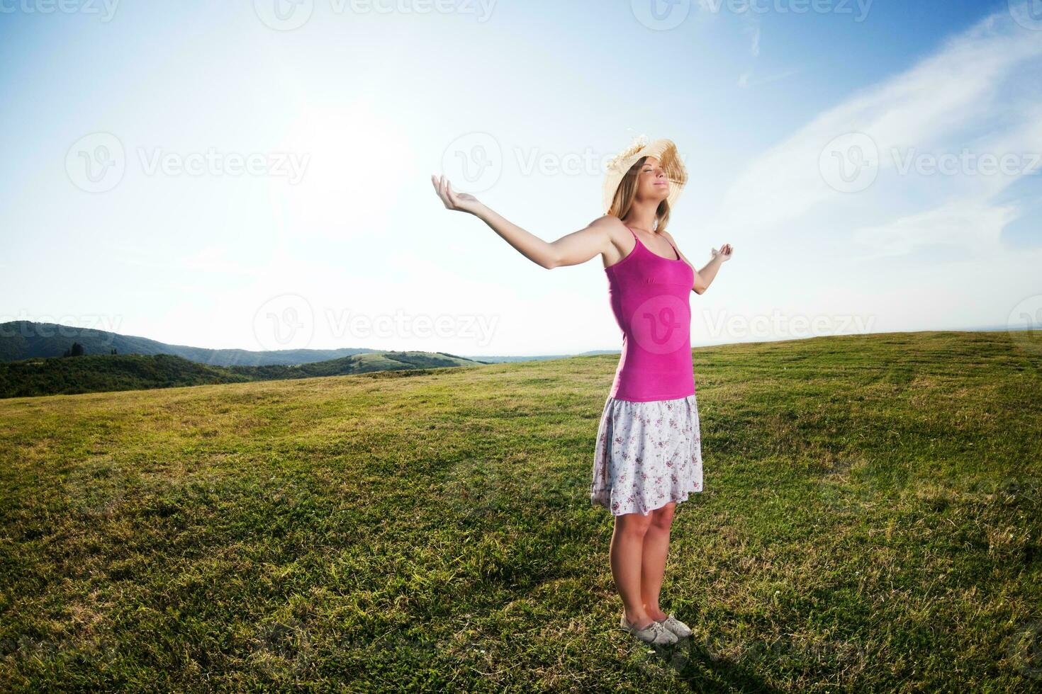 Woman with open arms outdoors photo