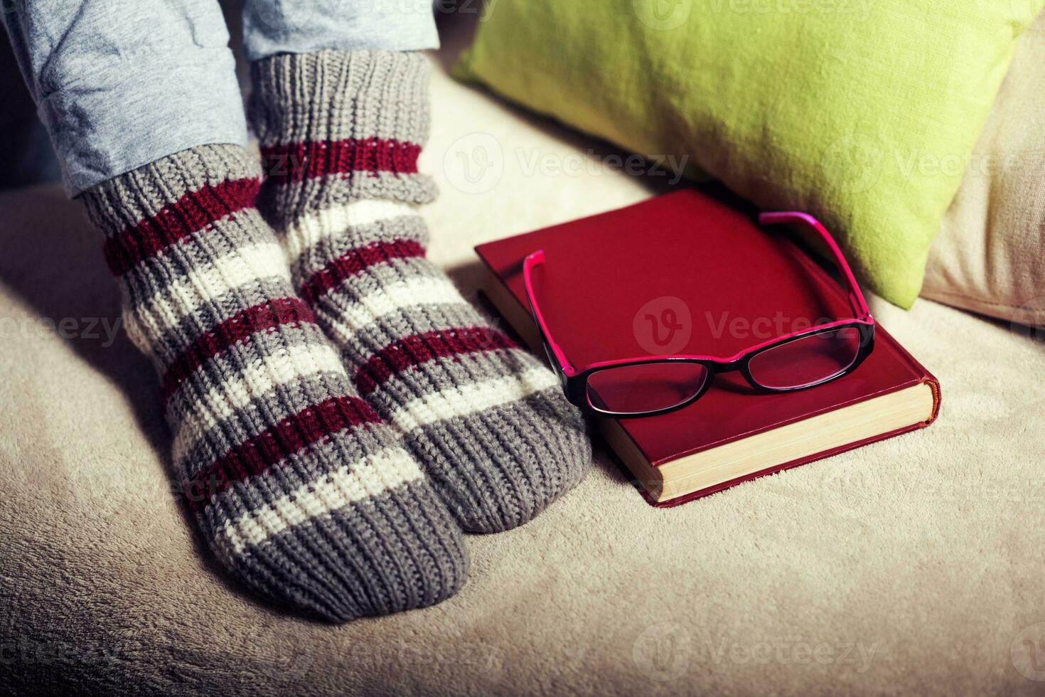 Feet with book and eyeglasses photo