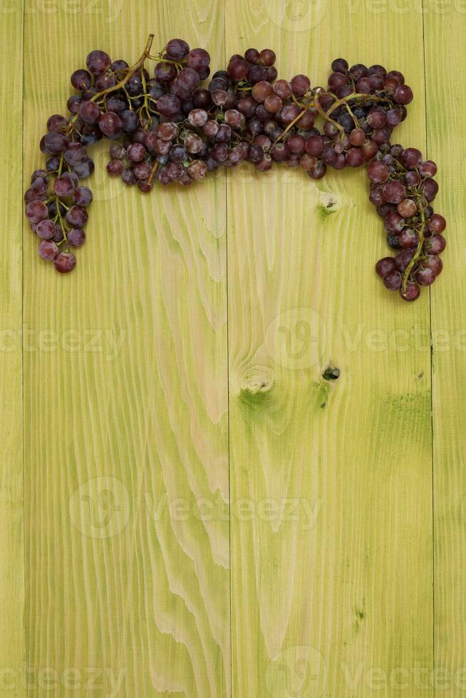 Organic grapes on wooden board photo