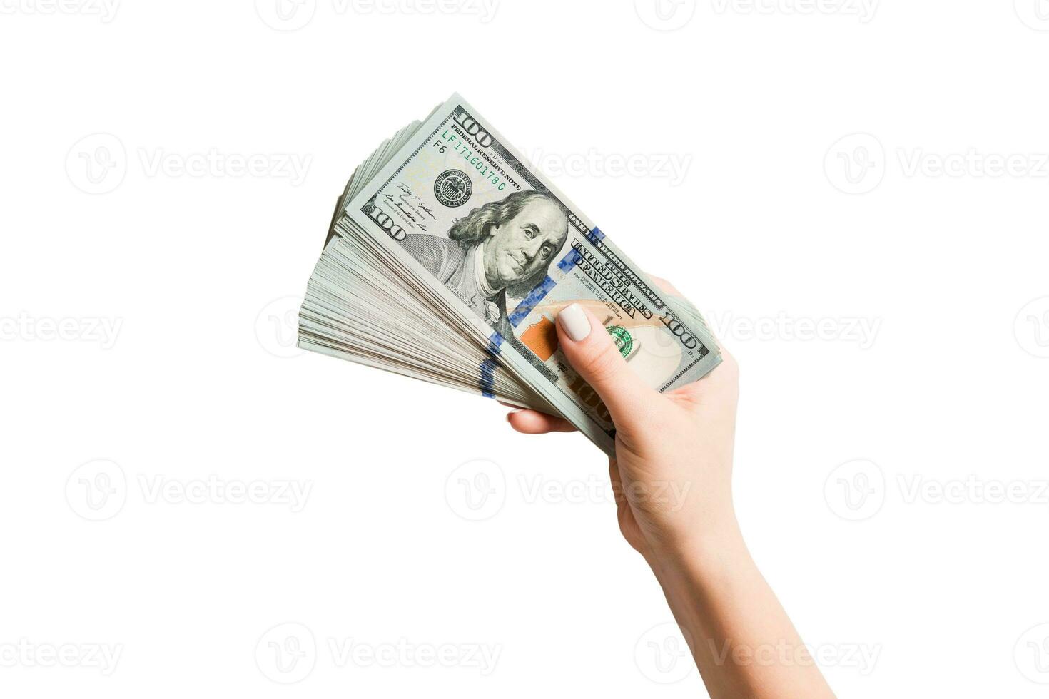 Female hand holding a fan of dollar banknotes on isolated background. Succes and investment concept photo