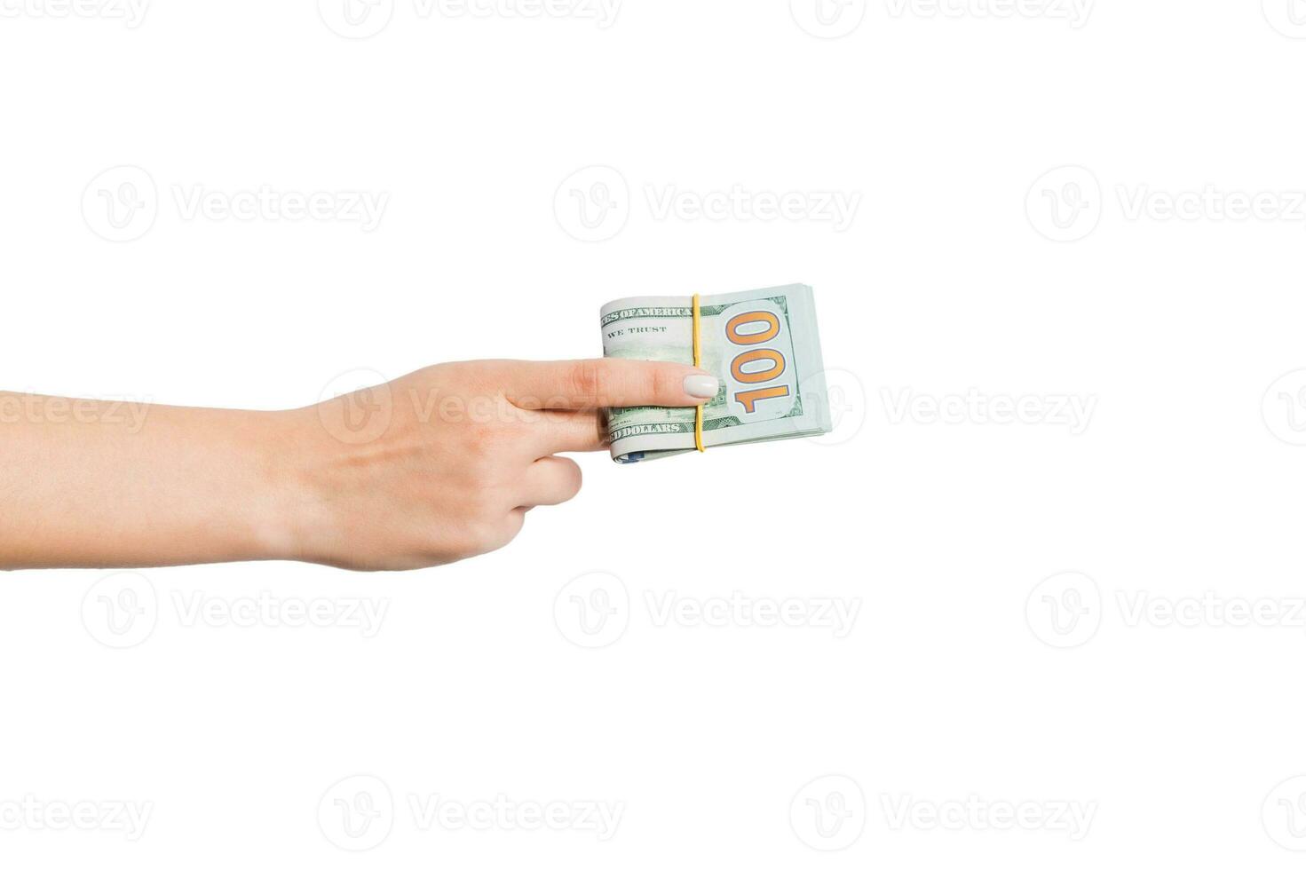 Female hand giving a bundle of dollar bills on white isolated background. Power and wealth concept photo