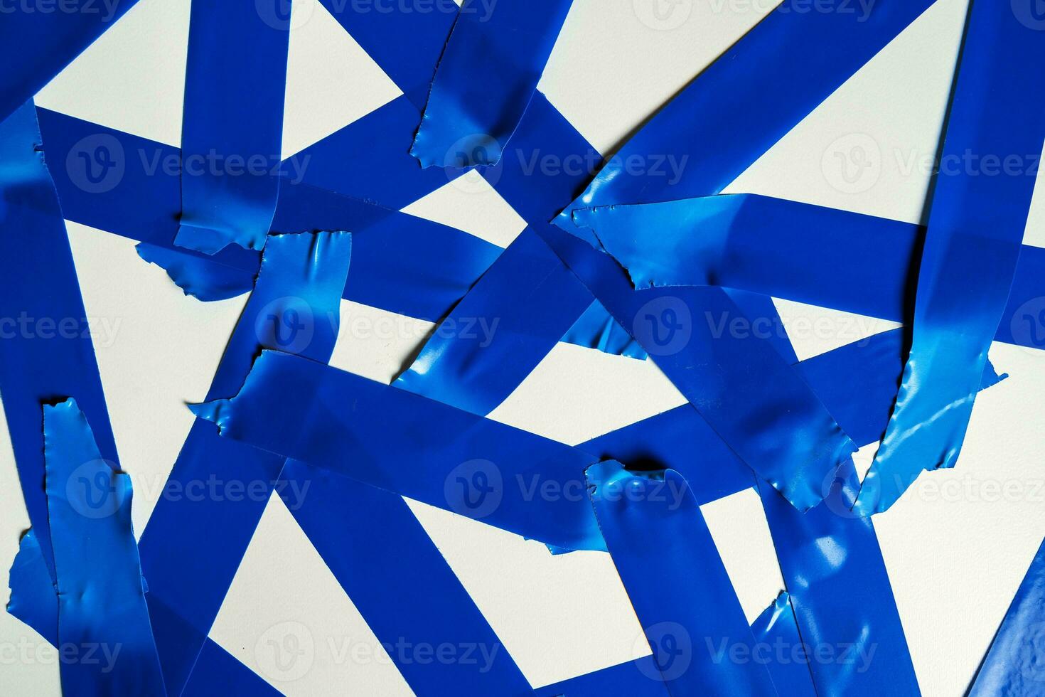 Torn blue sticky tape of different sizes isolated on a white background photo