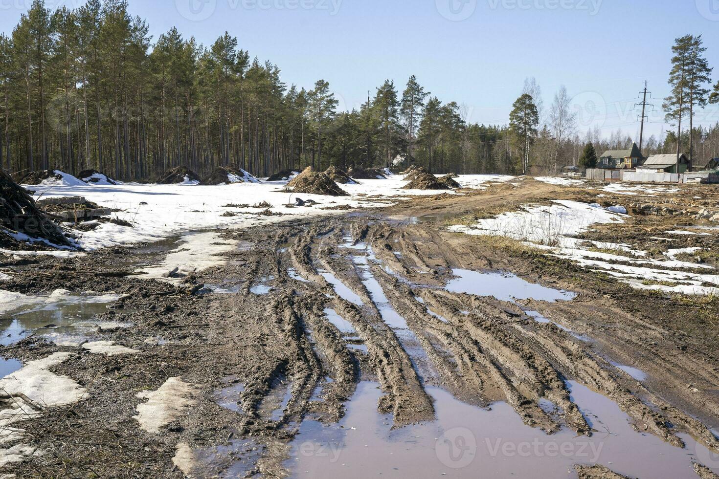 spring blurred country road with puddles and mud photo