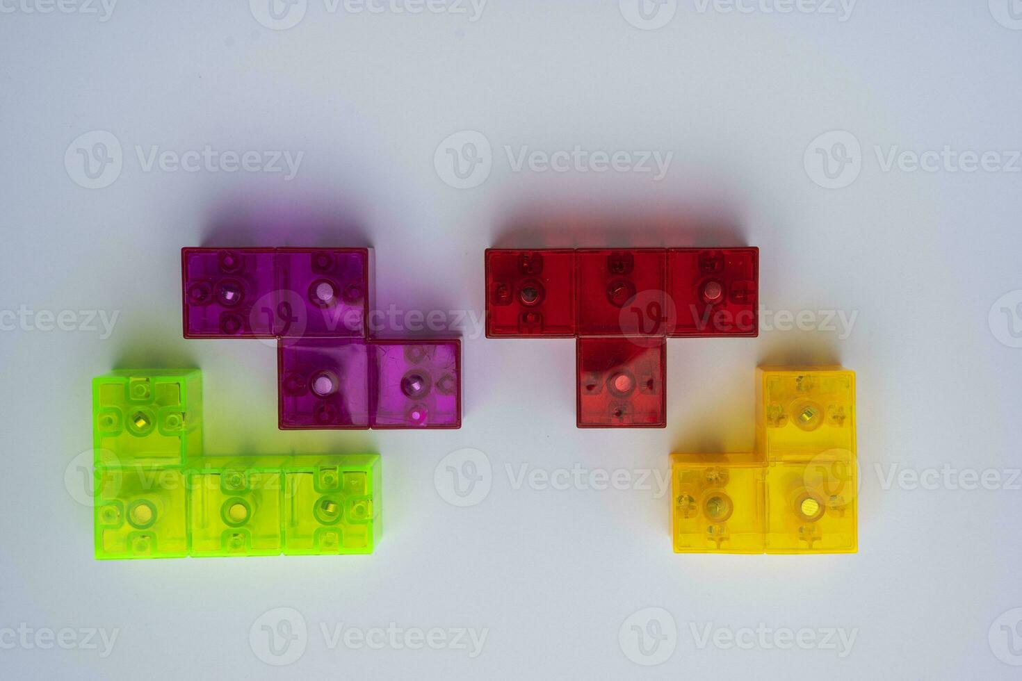 three-dimensional colored tetris figures on a white background photo