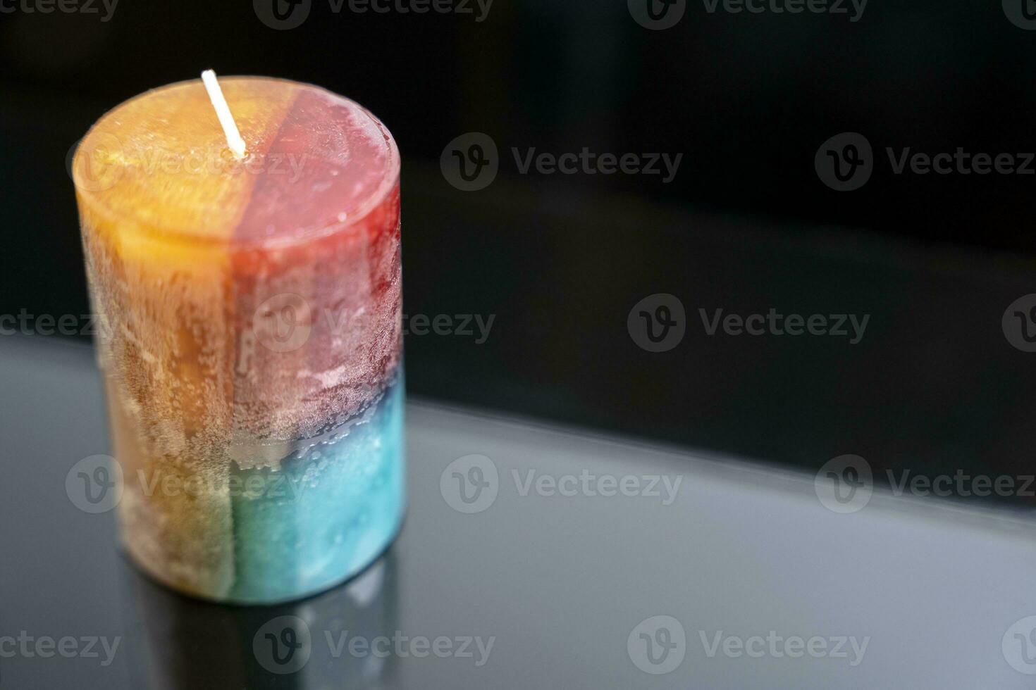 aromatic colored decorative candle on a dark background, aromatherapy photo