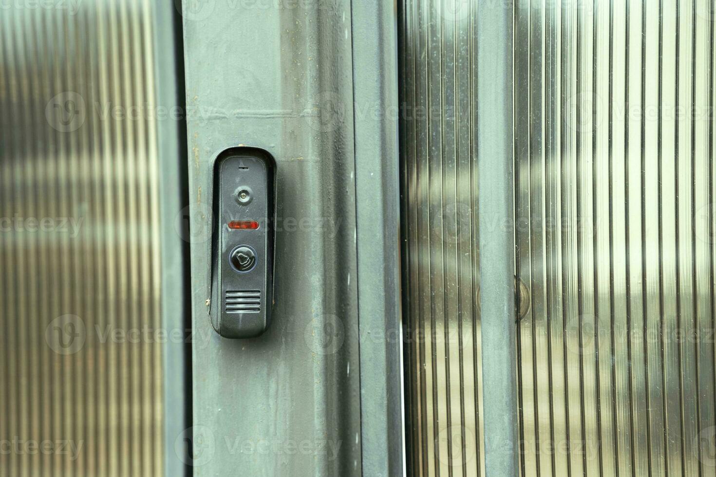 intercom panel with a video camera on the brick fence of private house photo