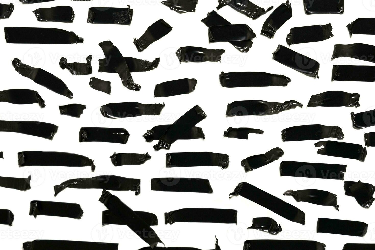 Torn black sticky tape of different sizes isolated on a white background photo