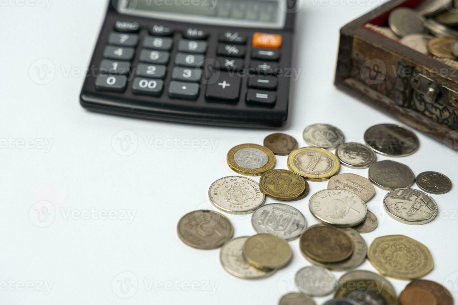 calculator, chest, coins on a white background. the concept of savings photo