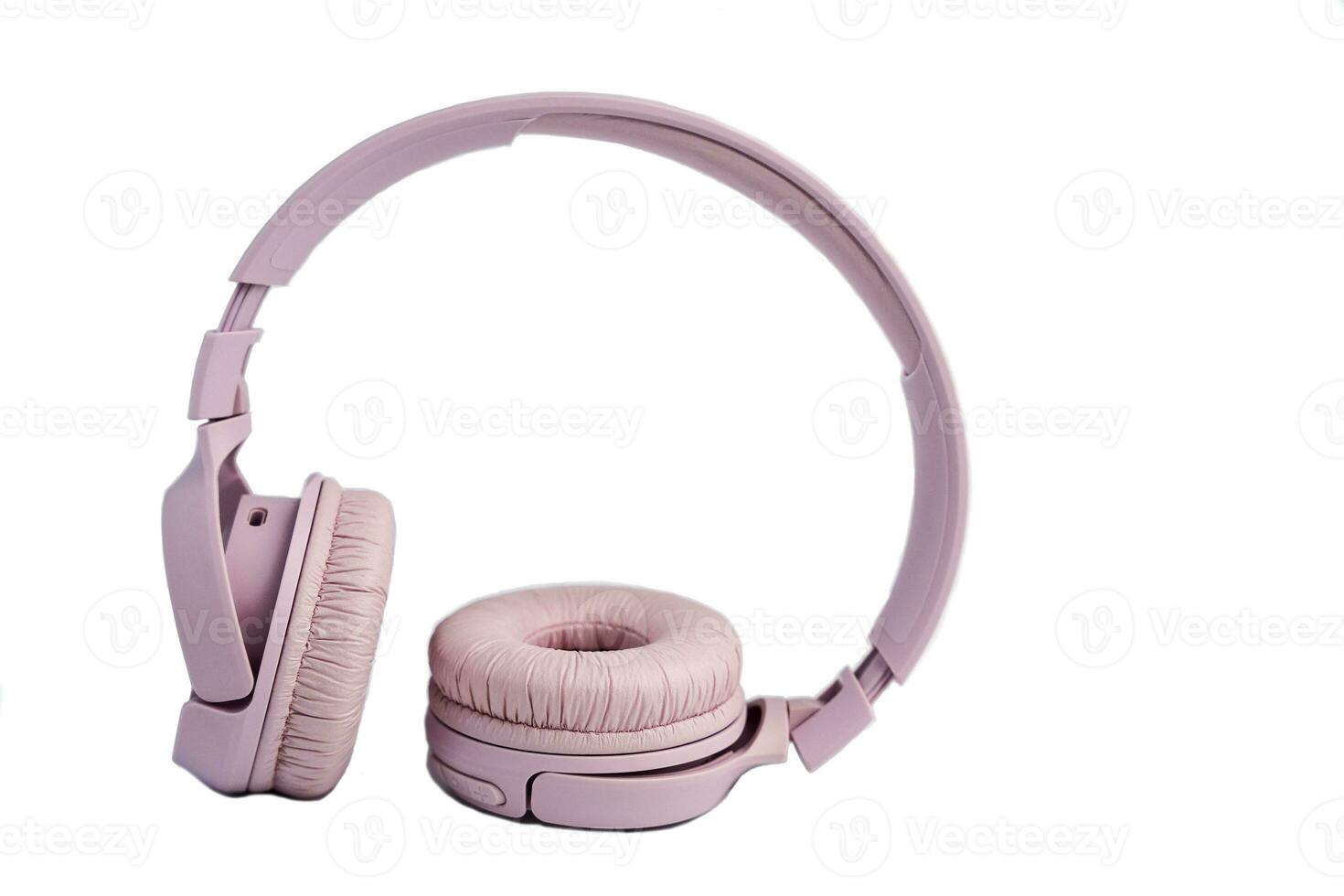pink wireless headphones isolated on a white background. Music time. space for text photo