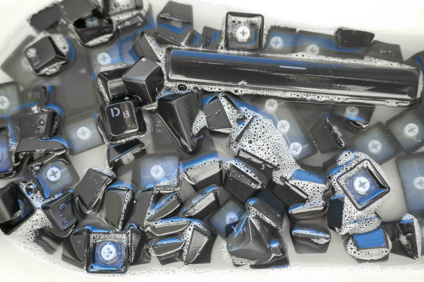 removed buttons of the keyboard sink with soap solution photo