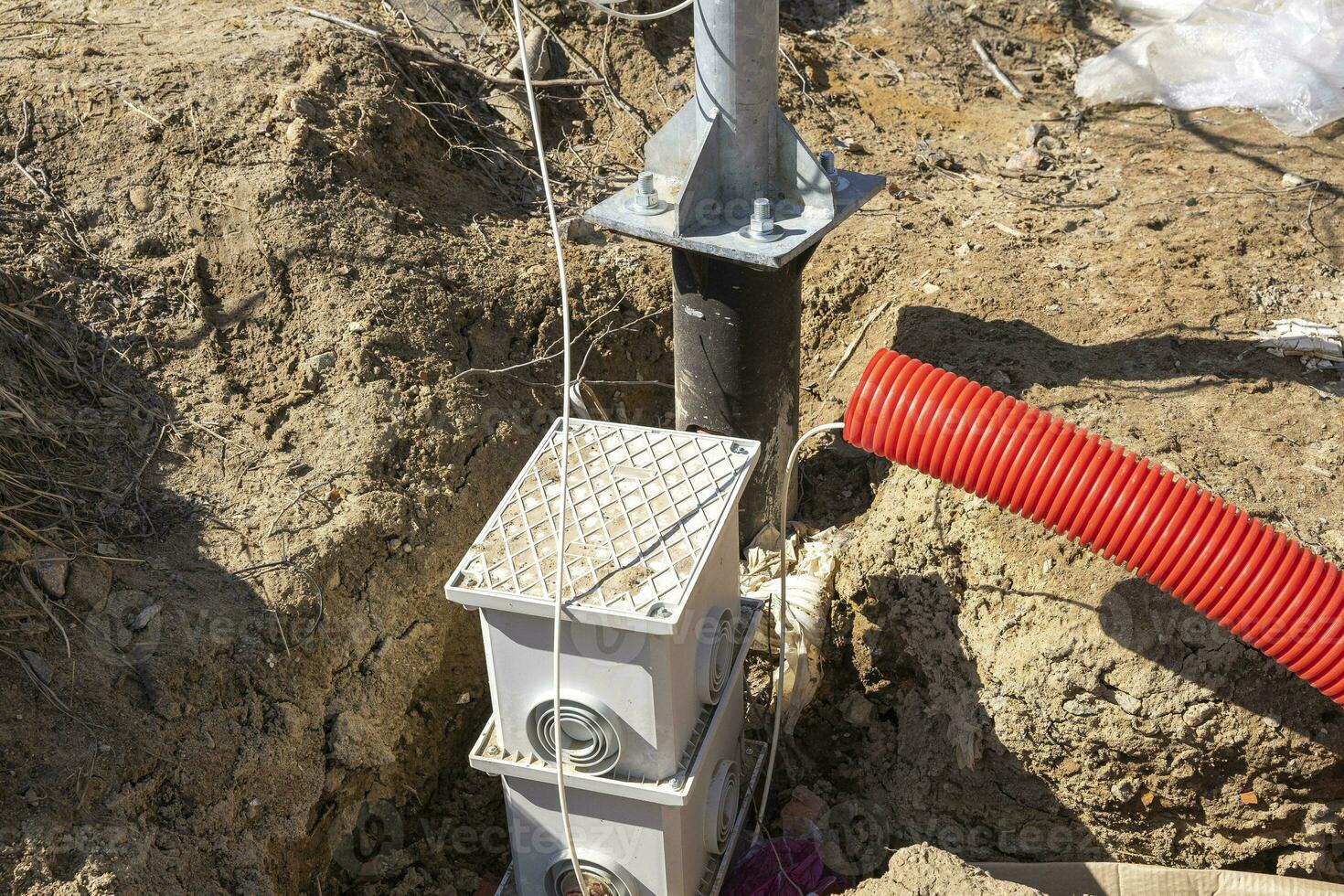 supply of an electric cable to a lamppost. laying of an electric cable