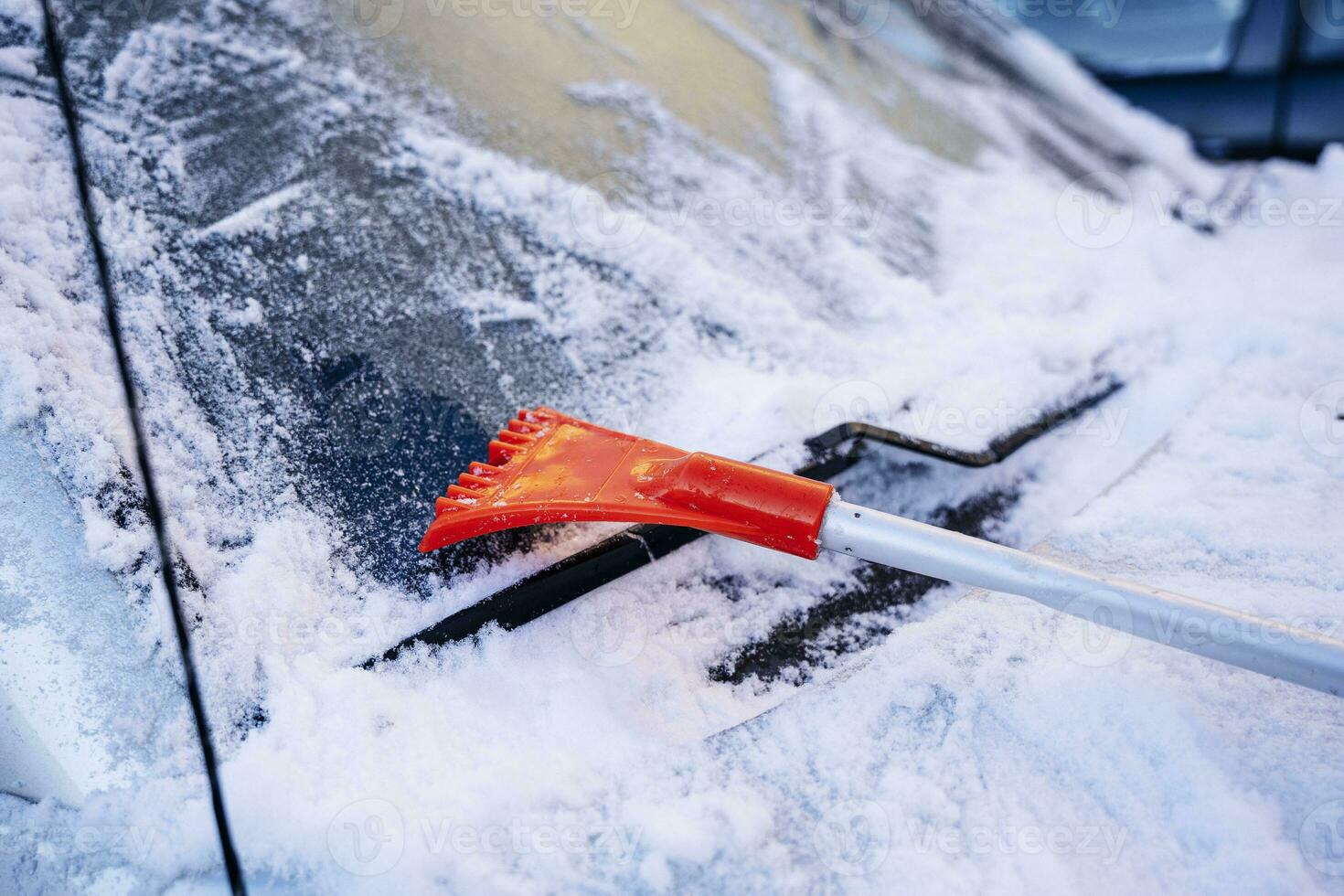 car brush-scraper for cleaning the car from snow and ice photo