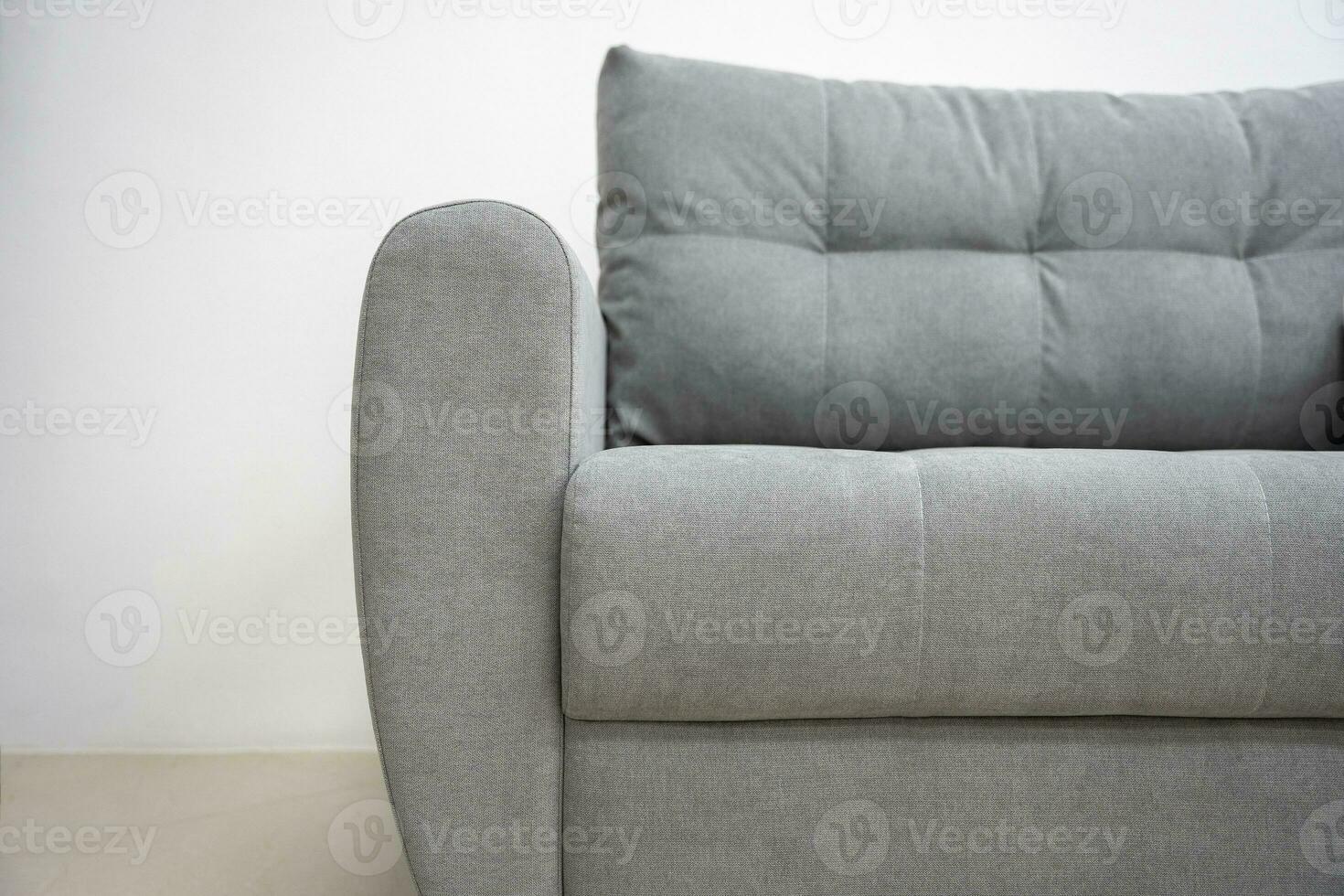 stylish fashionable grey sofa with back and armrests photo