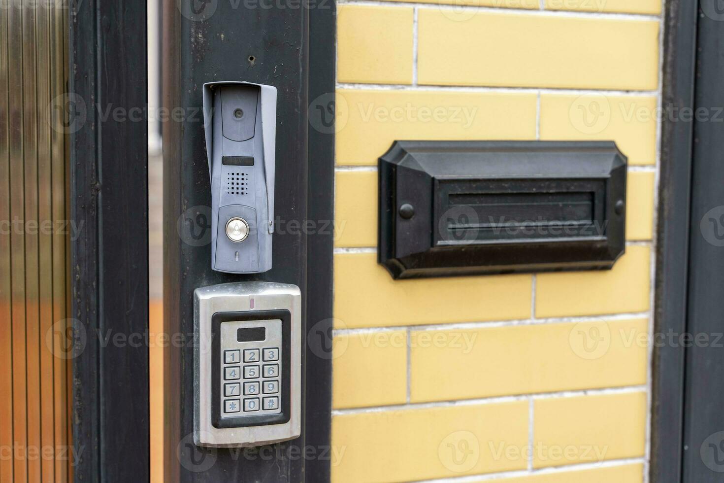 intercom panel with a video camera on the brick fence of private house photo