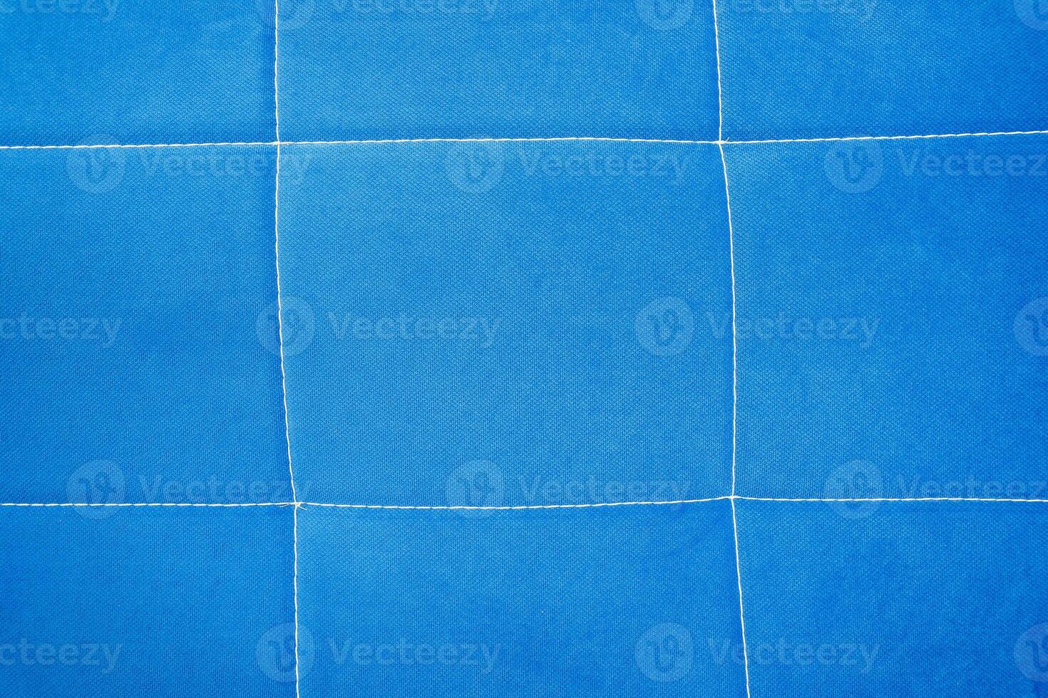 blue fabric backgroundbackground of blue fabric with stitching photo