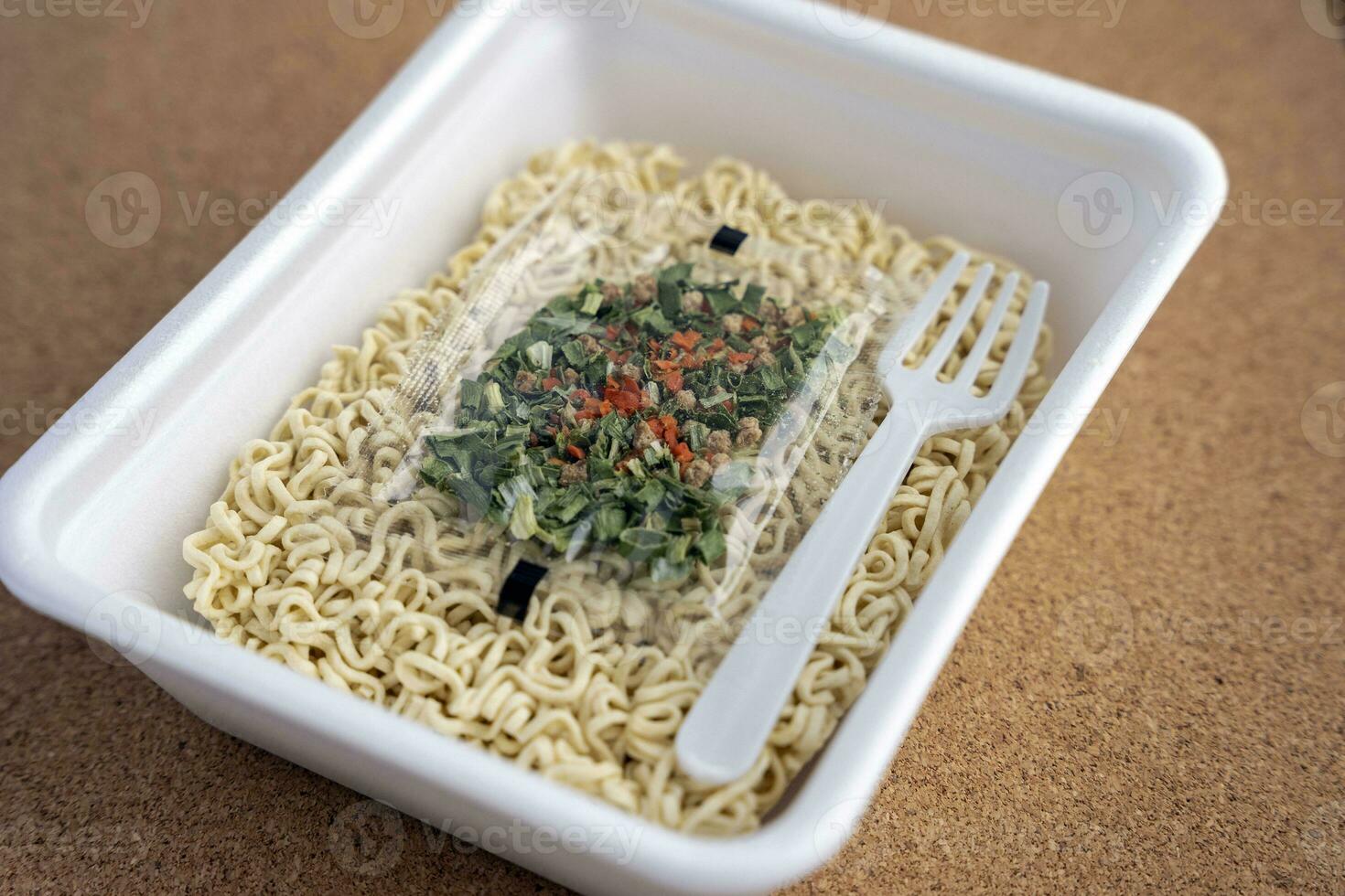 Chinese noodles with a bag of dried vegetables. close-up. Instant noodles photo