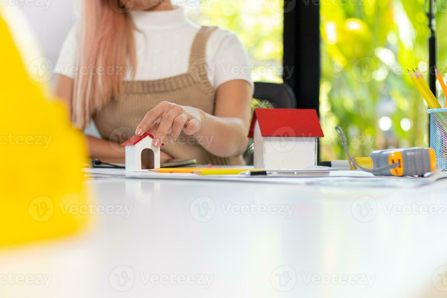 Engineers and designers are discussing the layout of the house and the construction schedule to be completed on schedule. House construction ideas with a team of professional engineers and designers. photo